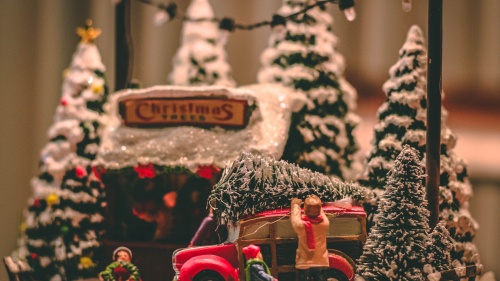 A miniature Christmas scene of gathering a Christmas tree.