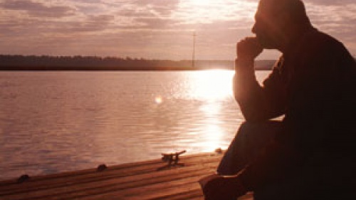 Man sitting on a pier