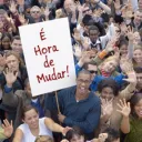 Man holding a sign in a crowd