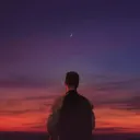 Uma pessoa olhando para o horizonte de um amanhecer.