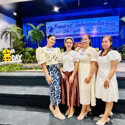 four ladies standing in front of a banner