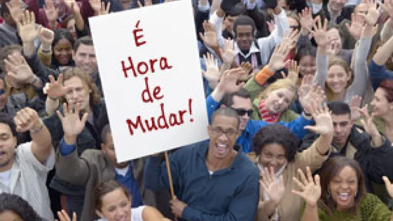 Man holding a sign in a crowd