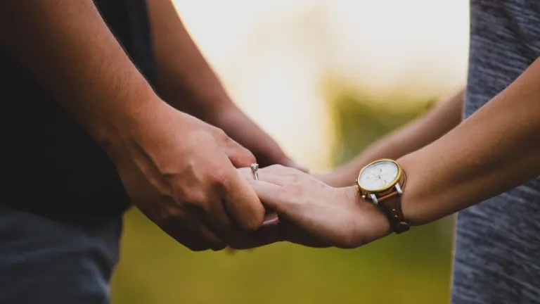 Nosso amorosíssimo e sapientíssimo Criador nos deu o Sétimo Mandamento para enaltecer e proteger o precioso relacionamento do casamento! Foto de um homem e uma mulher comprometidos de mãos dadas.