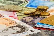 Cédulas de dinheiro, moedas e cartões de crédito.