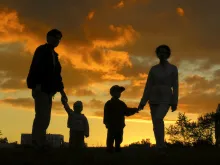 A silhouette of a family of four.