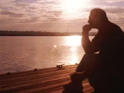 Man sitting on a pier